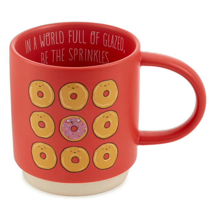 Red mug with donut designs and text on a white background