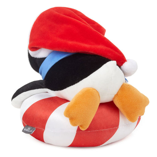 Plush toy resembling a cartoon character with a red hat and striped body on a white background