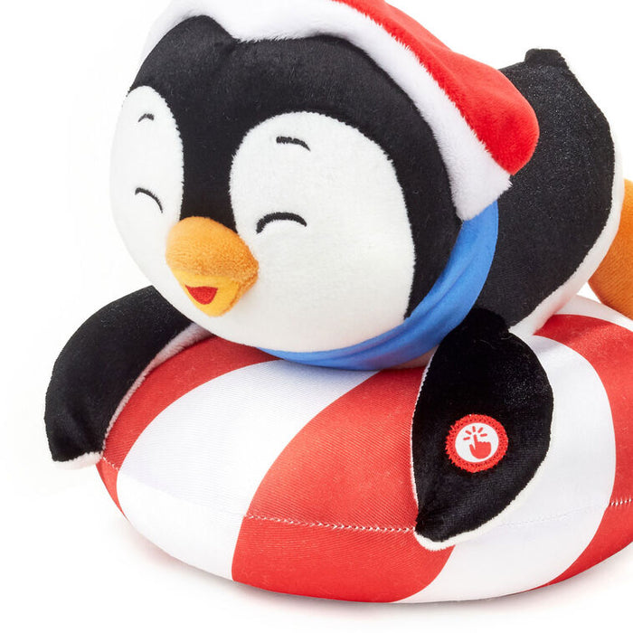 Plush penguin toy with a Santa hat and candy cane on a white background