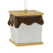 A s'mores-themed Christmas ornament shaped like a square marshmallow with a chocolate drizzle and a graham cracker top and base, hanging by a thin metal string against a plain white background.