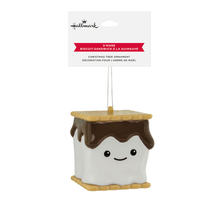 A Hallmark Christmas tree ornament shaped like a gummy biscuit sandwich with white marshmallow layers, brown chocolate spread, and tan graham cracker edges, hanging from a white retail card.
