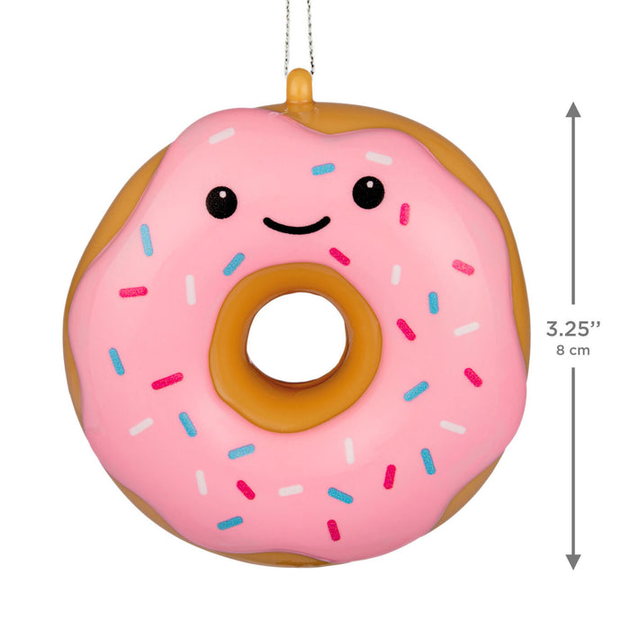 A pink frosted donut-shaped hanging ornament with a smiling face and multicolored sprinkles, shown on a white background with a vertical height measurement marker of 3.25 inches (8 cm) on the right side.