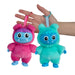 Two colorful plush toys, one pink and one blue, held in a hand against a white background.