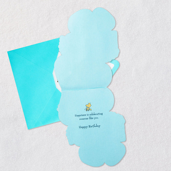 Blue birthday card with a small illustration and text on a textured surface