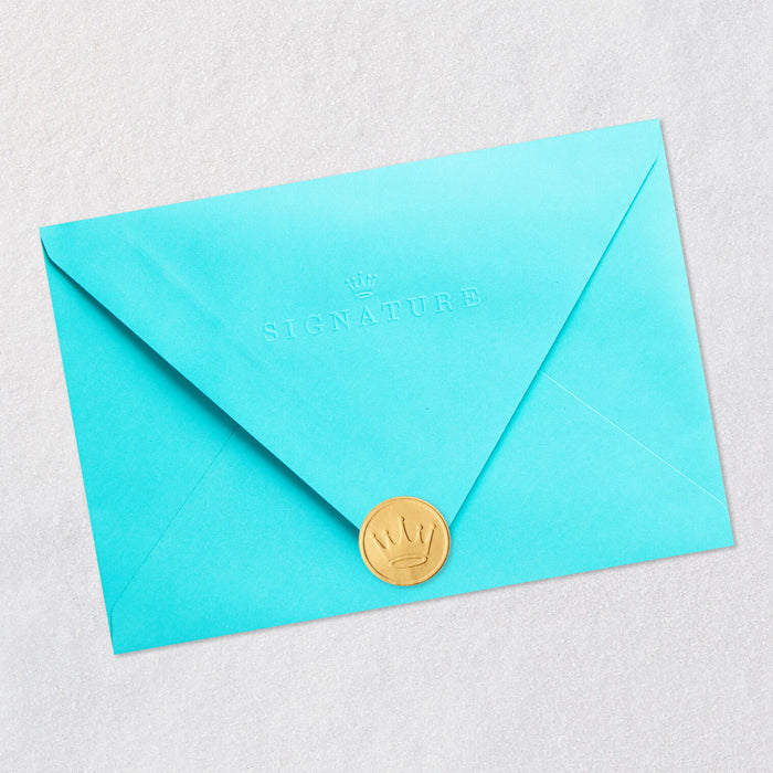 Turquoise envelope with a gold seal on a light gray background