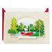 Greeting card with a cartoon character in a red canoe surrounded by trees, with 'Happy Birthday' text.