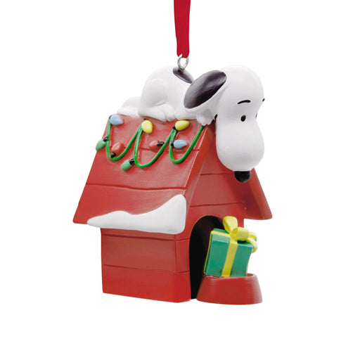 Snoopy Christmas ornament with doghouse, gift, and lights on a white background