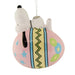 Decorative ornament featuring a cartoon dog character on a pink ball with colorful patterns.