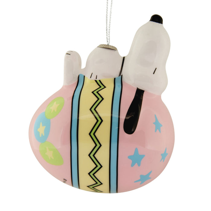 Decorative ornament with a dog character on a pink round base with patterns