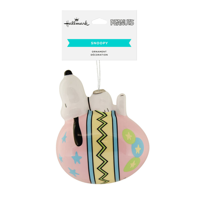 Snoopy ornament with a pink base and colorful patterns, featuring the Hallmark logo.