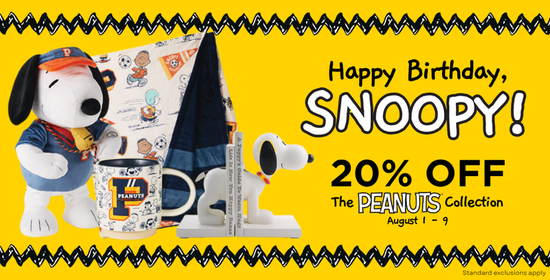 A promotional banner for the Peanuts collection celebrating Snoopy's birthday, featuring Snoopy in a baseball uniform next to a mug, a notebook, and a small model airplane on a bright yellow background with text offering 20% off.