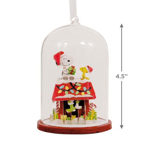 Christmas-themed ornament with a clear dome, featuring Snoopy and Woodstock, on a white background.