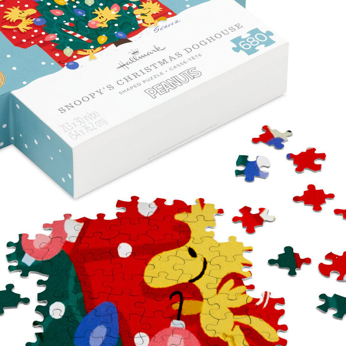 Peanuts-themed puzzle with Snoopy and Woodstock, featuring a completed section and scattered pieces, with a 'Hallmark' branded box.