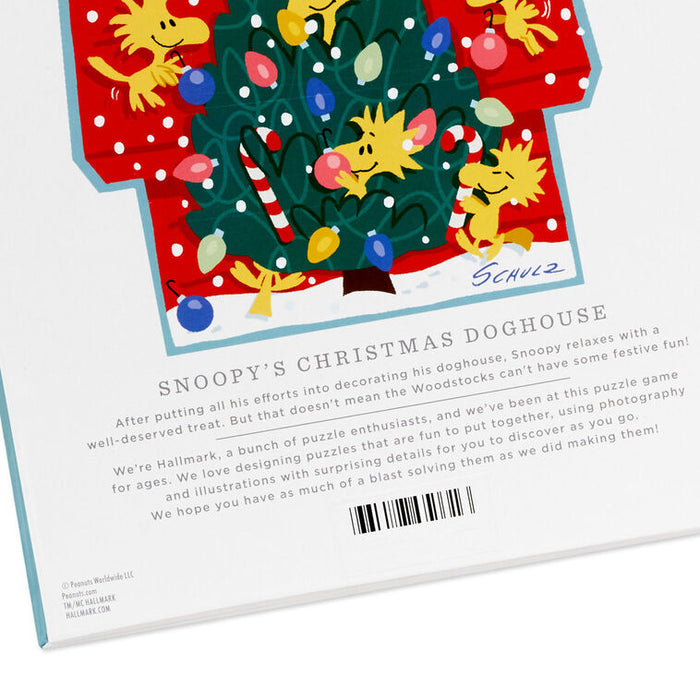 Hallmark Snoopy's Christmas Doghouse puzzle packaging with cartoon characters around a decorated tree.