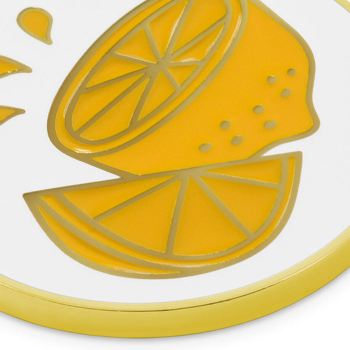 A close-up of a round white plate or tray with a glossy yellow lemon illustration and a gold rim, shown against a white background.