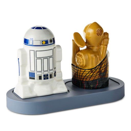 Two decorative figurines on a stand, one resembling R2-D2 from Star Wars and the other resembling a character from a different franchise.