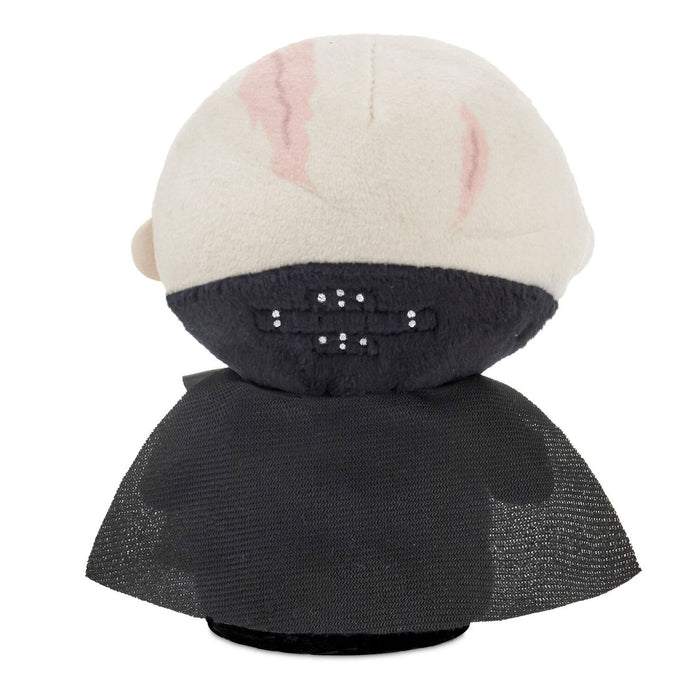 Plush toy with a black body and white head with pink ears on a white background