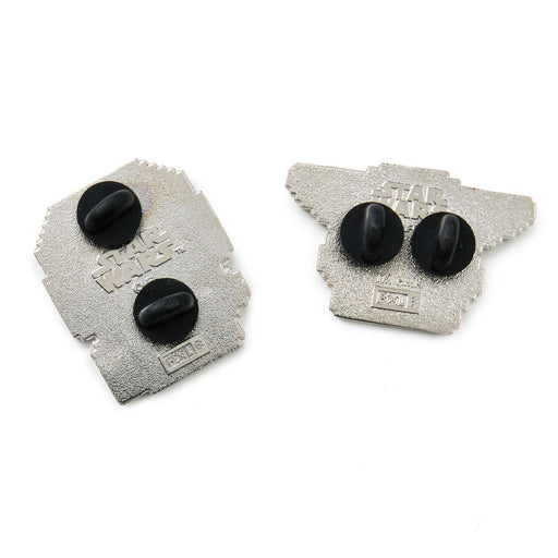 Two metallic objects with black components on a white background