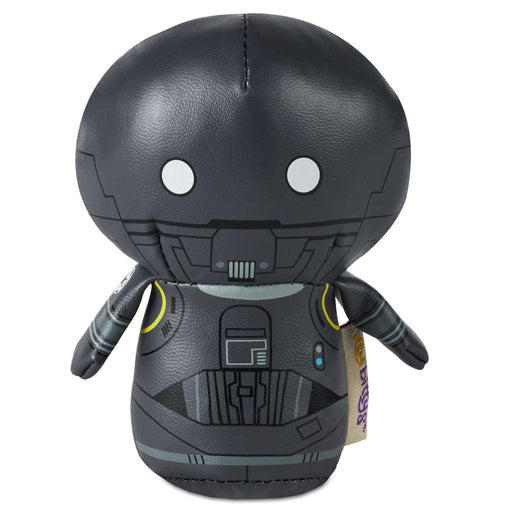 Black robot plush toy with white eyes on a white background