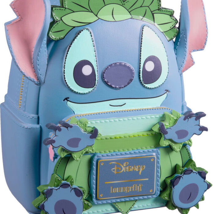 Disney Loungefly Stitch backpack in light blue and green, featuring Stitch's face, pink ears, and decorative green leaves and flowers, with a visible Disney Loungefly plaque on the front.