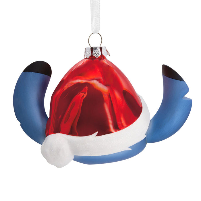 Decorative ornament with a red hat, blue wings, and white trim on a white background