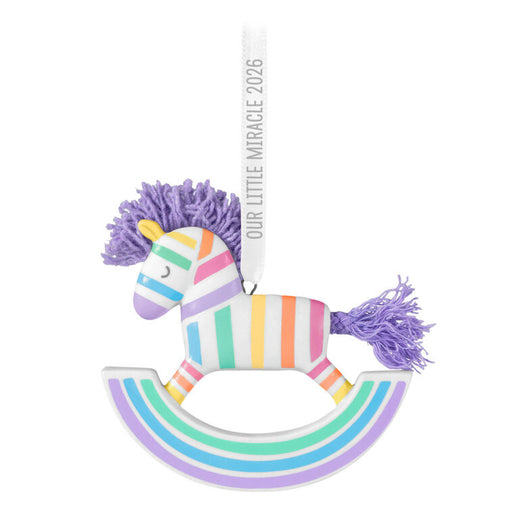 Colorful rocking horse toy with tassels on a white background