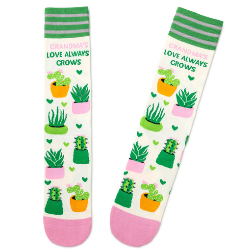 Pair of socks with cactus design and text 'Grandma's love always grows' on a white background