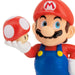 Super Mario figurine holding a red mushroom against a white background