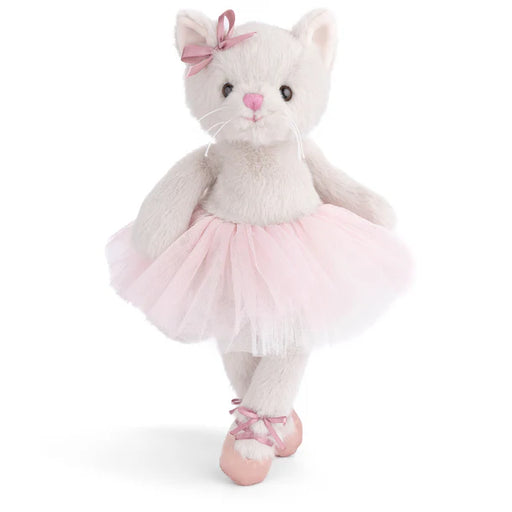 Plush toy cat in a ballerina outfit with a pink bow on a white background