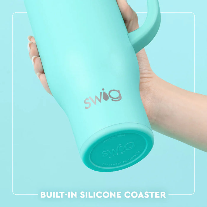 Turquoise mug with 'swig' branding held by a hand against a light blue background