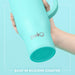 Turquoise mug with 'swig' branding held by a hand against a light blue background