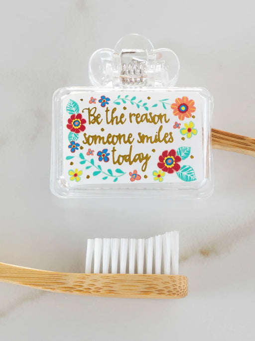 Bamboo toothbrush with motivational quote on a white background