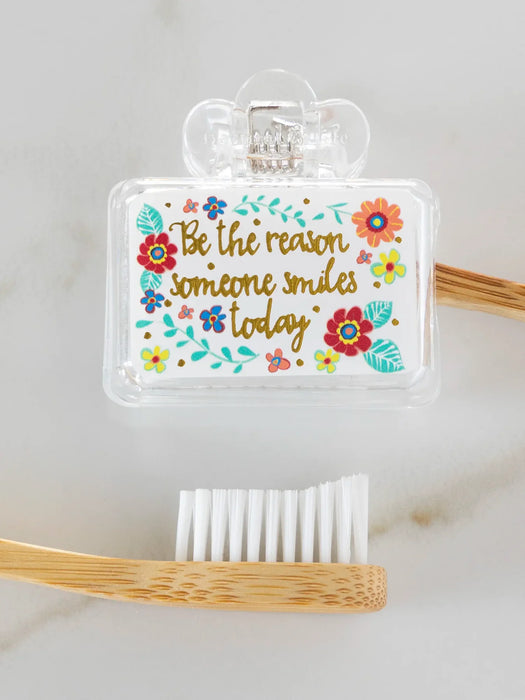 Bamboo toothbrush with motivational quote on a white background