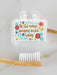 Bamboo toothbrush with motivational quote on a white background