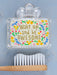 Toothbrush with a holder containing a motivational quote and colorful design on a blue background