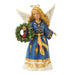 An angel Christmas figurine with long blonde hair, wearing a blue robe with gold trim and holding a green wreath with a small red bird, set against a plain white background.