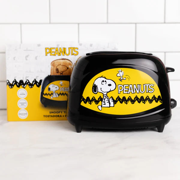 Black toaster with 'Peanuts' branding on a white surface