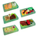 Set of miniature food items in green trays on a white background