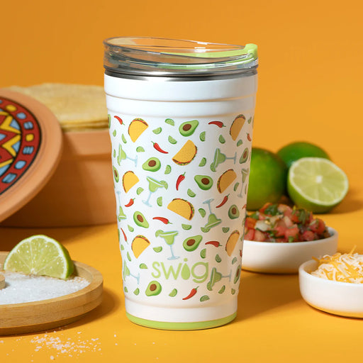Swig tumbler with taco pattern on a yellow background with food items
