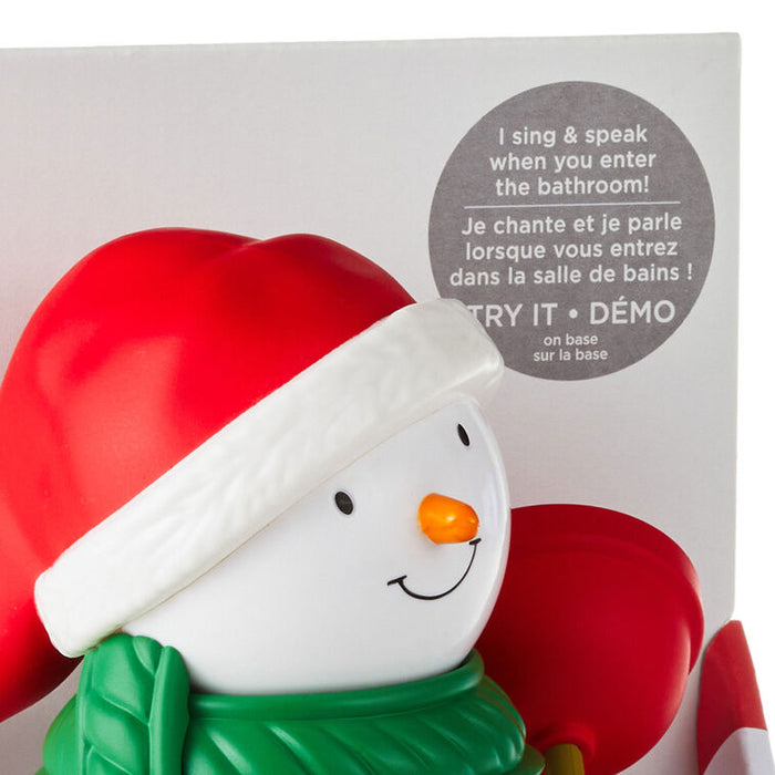 Snowman-shaped product with red hat and green scarf in front of packaging