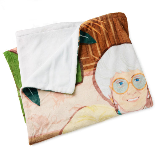 Folded blanket with a printed design of a person wearing glasses on a white background