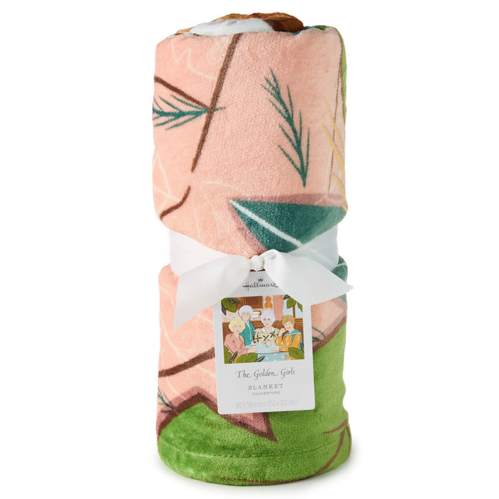 Folded blanket with a geometric pattern and a visible brand label on a white background