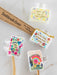 Set of colorful toothbrush covers with motivational phrases on a marble surface.