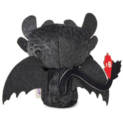 Black plush dragon toy with wings on a white background