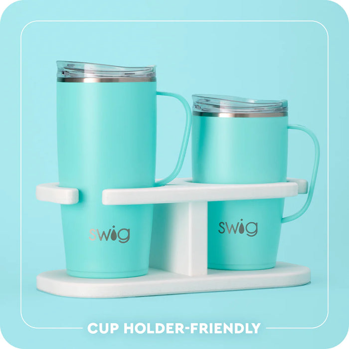 Two turquoise mugs with a white stand on a light blue background, featuring the 'swig' brand.