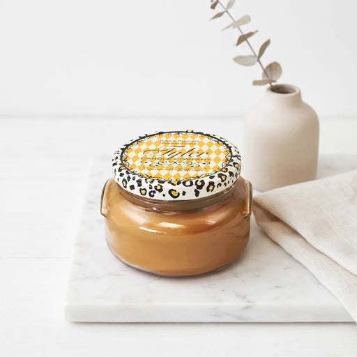 Tyler Cowboy Candle Collection scented candle in a clear glass jar with a Cowboy label and metal lid displayed on a white background.