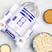 Star Wars R2-D2 popcorn maker with bowls of popcorn and kernels on a marble surface