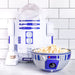 R2-D2 popcorn maker with a bowl of popcorn on a white tiled background