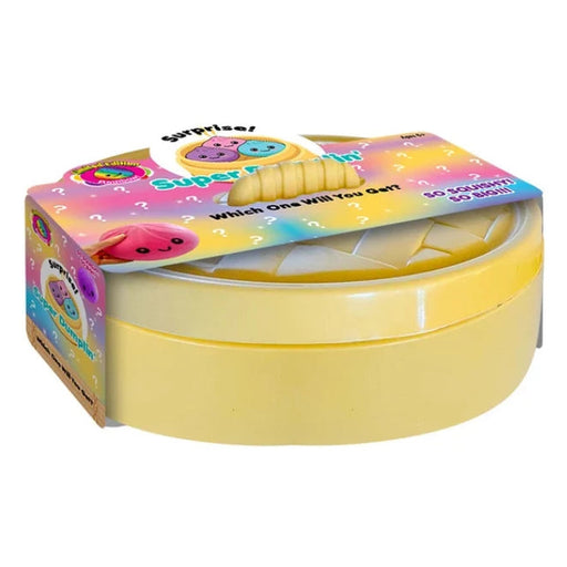 A yellow plastic toy container with a colorful printed cardboard lid, featuring cartoon graphics and text including 'Super Dumplin' and 'Which One Will You Get?'.