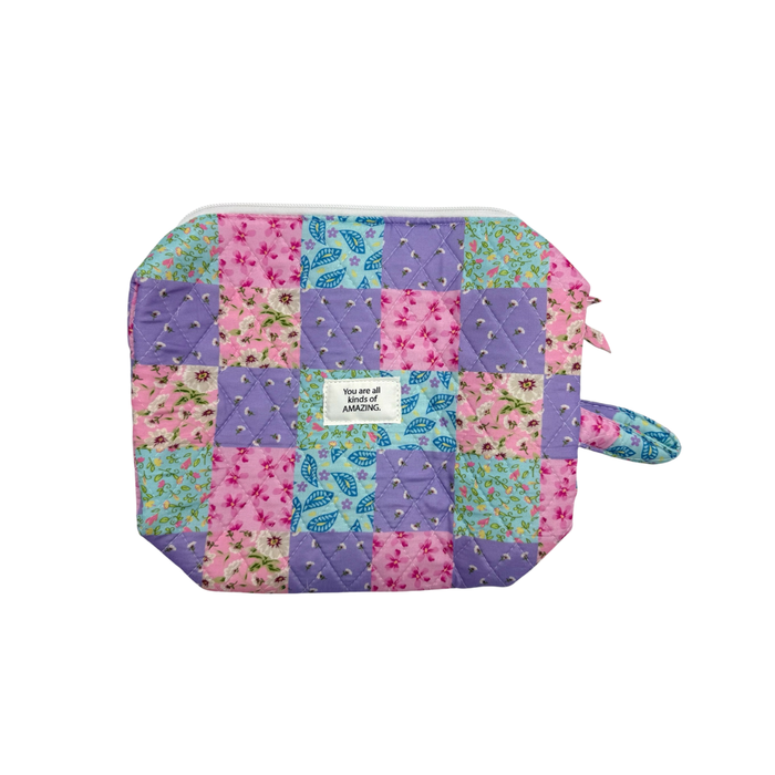 Patchwork-style pouch with floral patterns on a white background